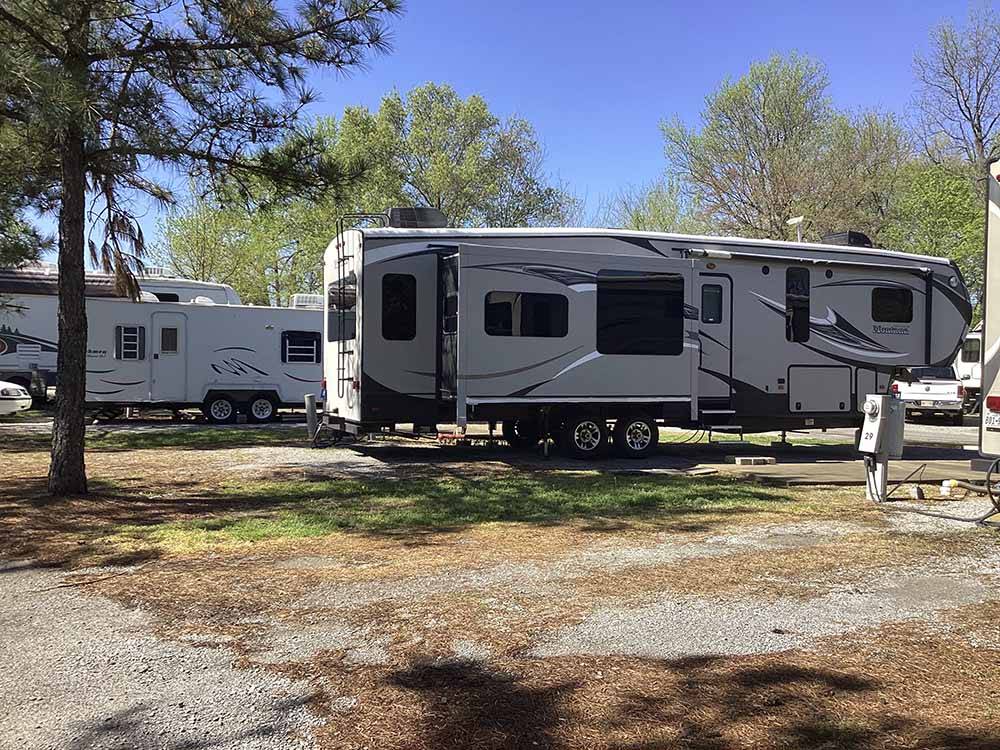 A fifth wheel trailer in a gravel RV site at SOUTHAVEN RV PARK
