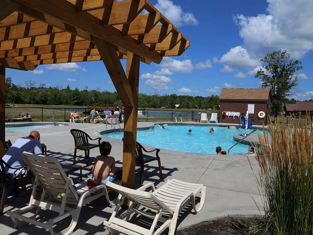 Swimming pool with deck chairs and canopy at HTR NIAGARA