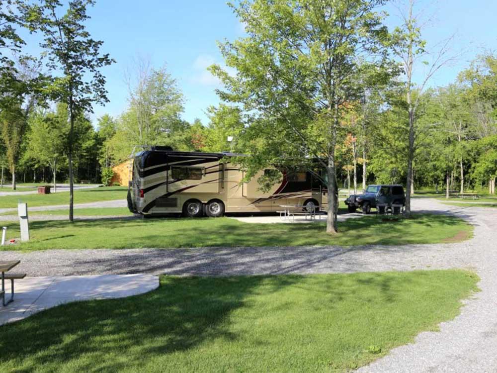 Tag axle motorhome in campsite with two vehicle at HTR NIAGARA