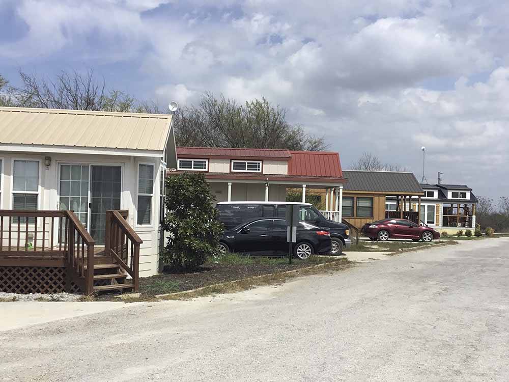 A row of rental manufactured homes at HOOVES N' WHEELS RV PARK & HORSE MOTEL