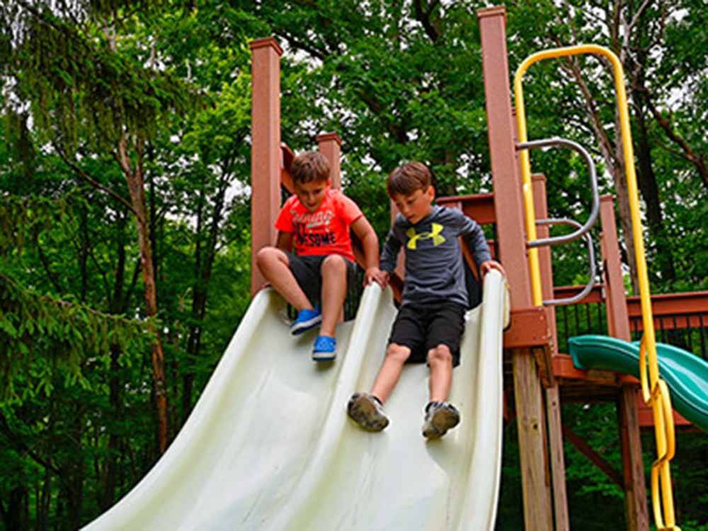 Two kids going down a slide at STONYBROOK RV RESORT