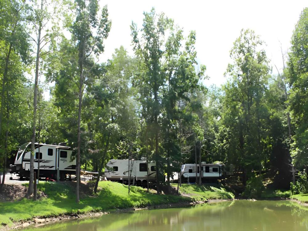 Parked trailers at site Little River RV Park & Campground