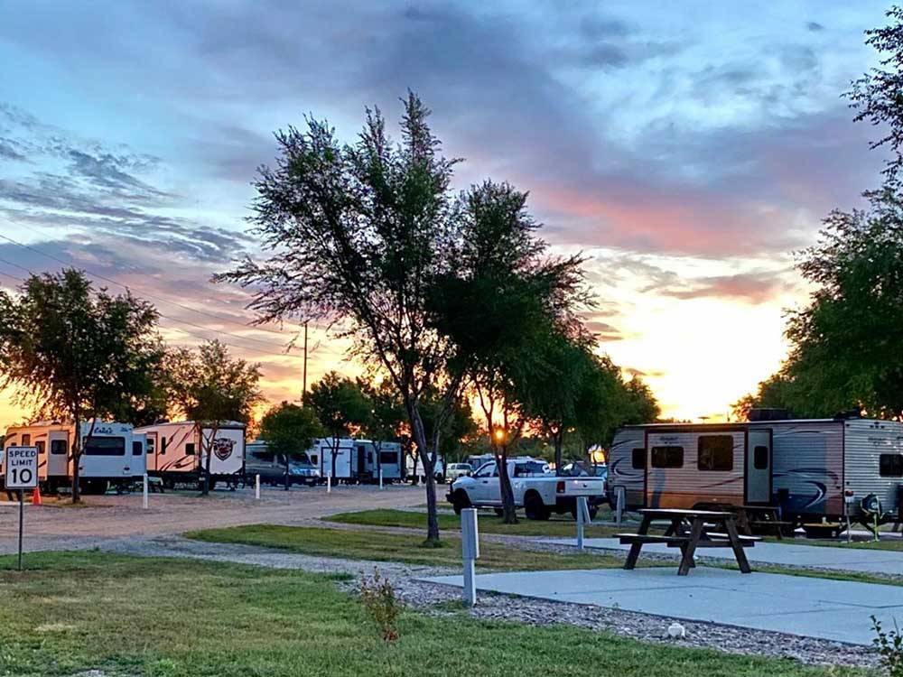A row of paved RV sites at dusk at KEARNEY RV PARK & CAMPGROUND
