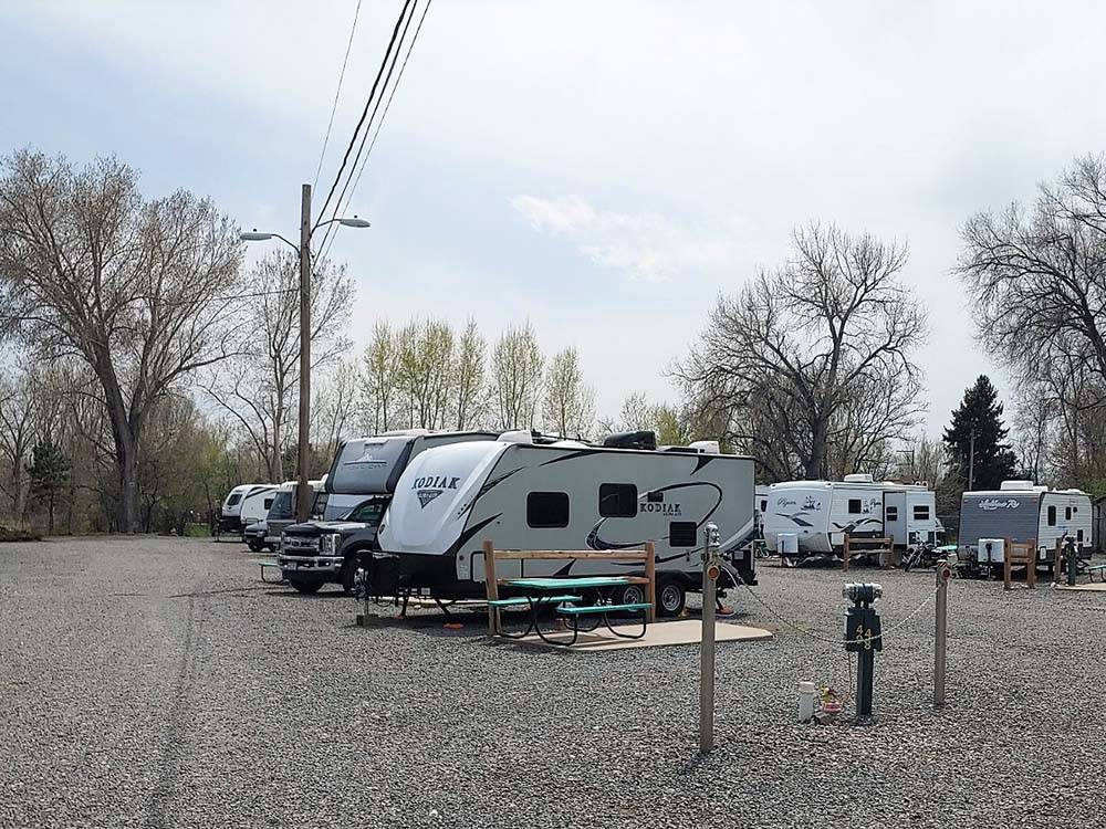 RVs parked with picnic benches at APPLEWOOD RV RESORT BY RJOURNEY