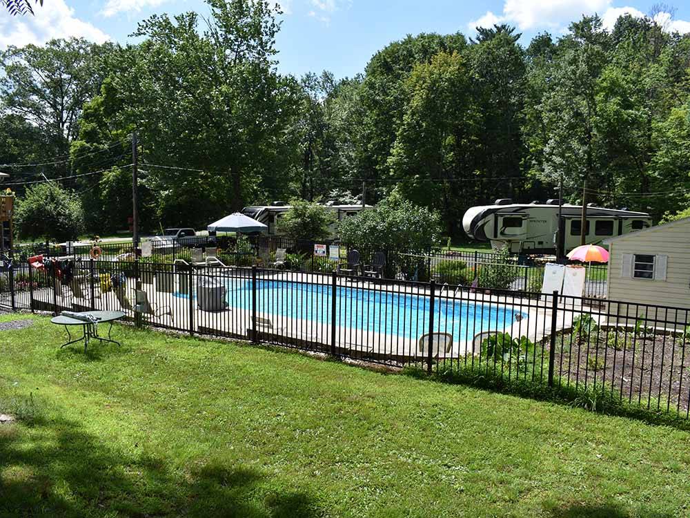 The fenced in pool area at WHISPERING PINES CAMPING ESTATES