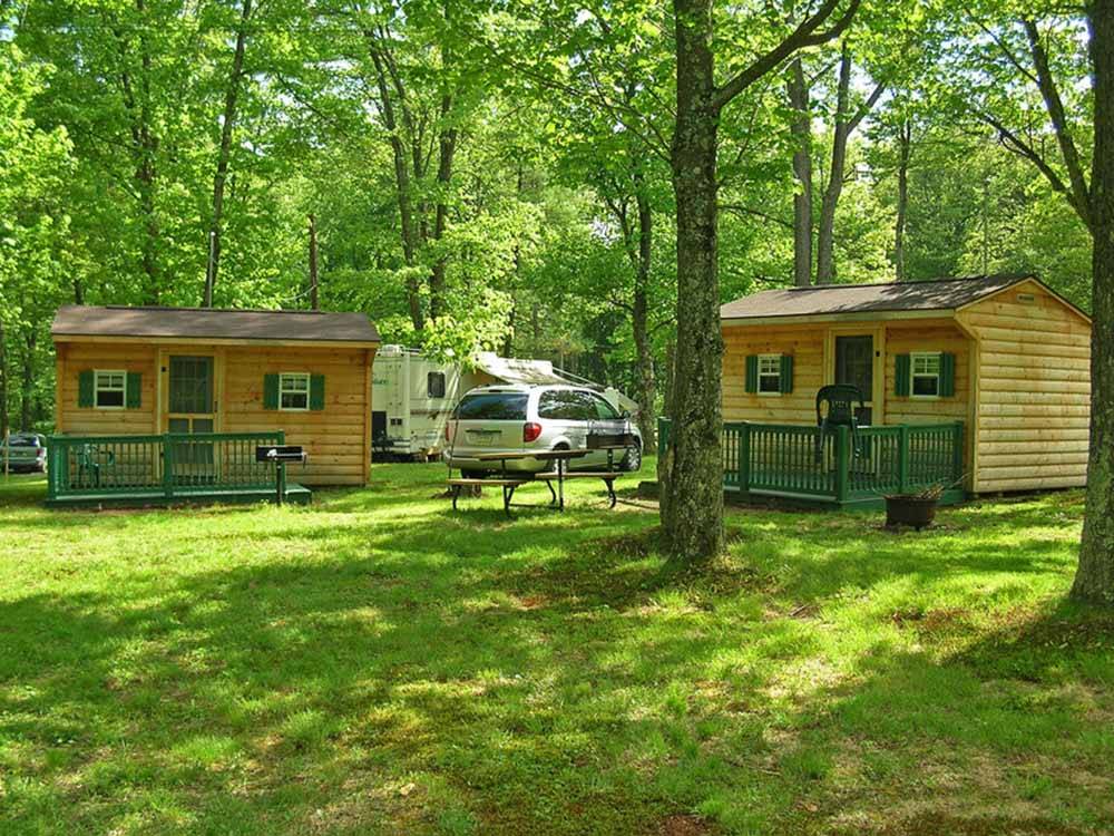 A couple of rental log cabins at WHISPERING PINES CAMPING ESTATES