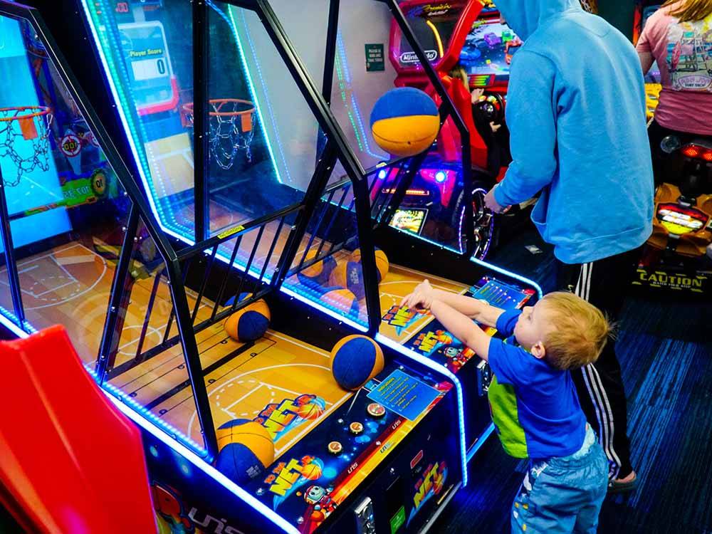 A little boy playing one of the arcade games at THE HILL CAMPGROUND