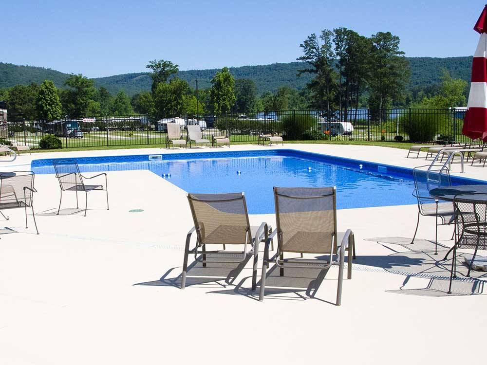 Swimming pool with outdoor seating at WINDEMERE COVE RV RESORT