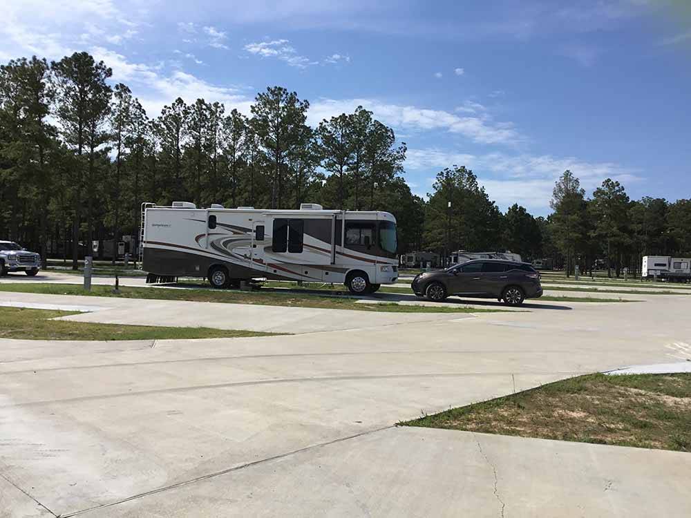 A row of paved RV sites at BLUE SKY LAKE LIVINGSTON RV PARK & CABINS