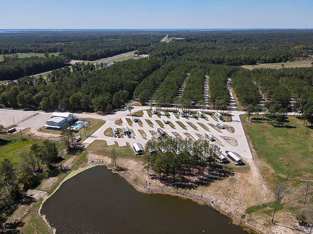 An aerial view of the RV sites and lake at BLUE SKY LAKE LIVINGSTON RV PARK & CABINS
