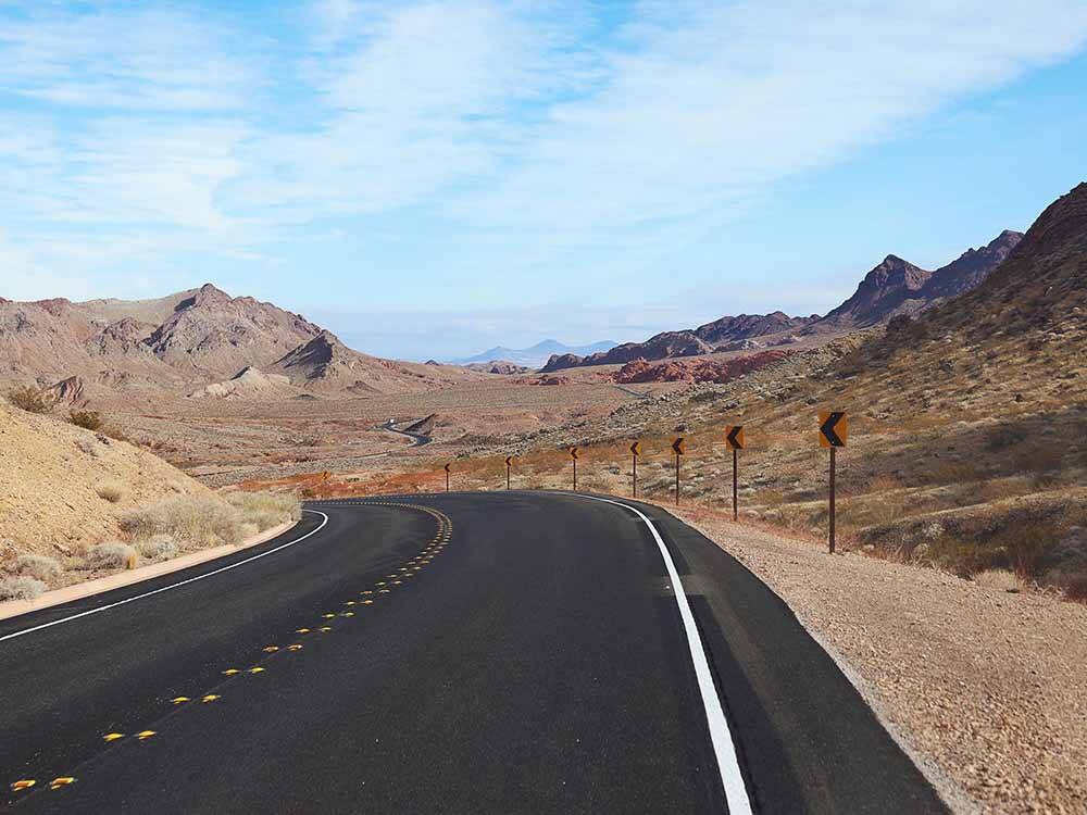 A paved highway turning left at LAKE MEAD RV VILLAGE AT ECHO BAY