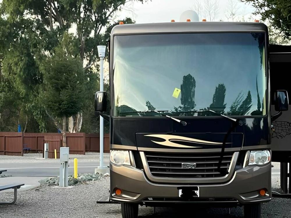 RV parked at a gravel site at Avila Pismo Beach KOA