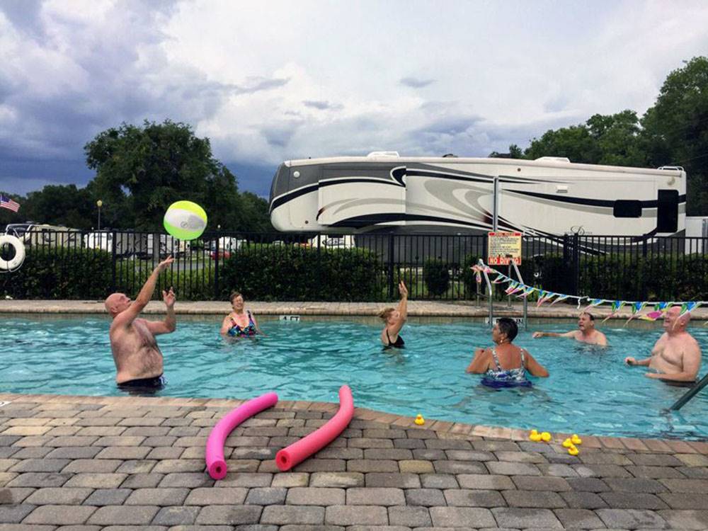 Guest playing volleyball in the pool