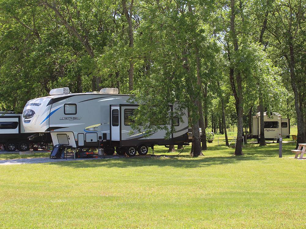 A fifth wheel parked at a site