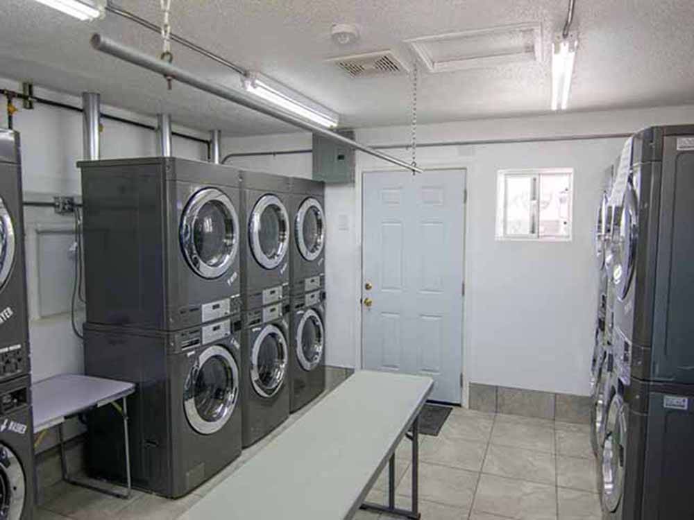 Laundry facilities with multiple washers and dryers at DESERT PUEBLO RV RESORT