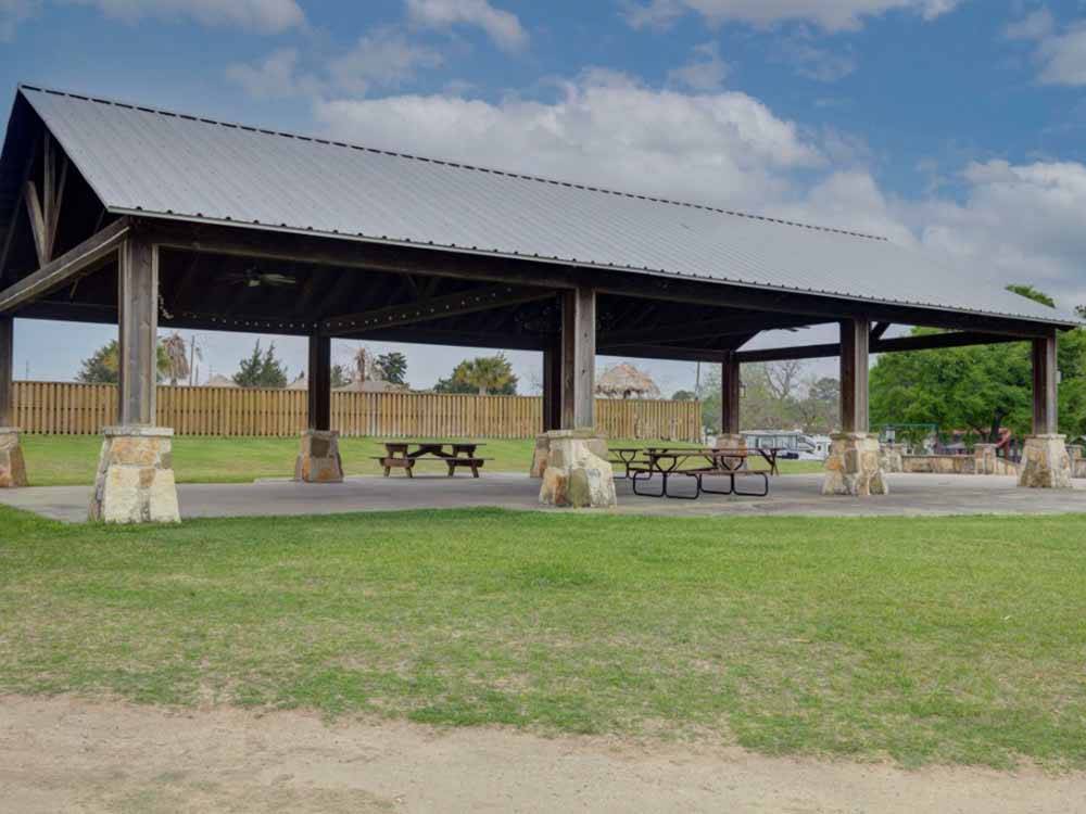 Pavilion with picnic tables at WATER'S EDGE RV RESORT