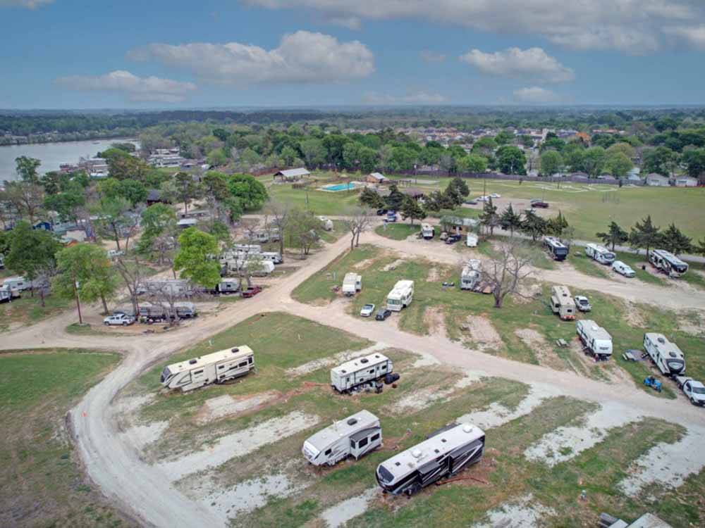 View of campsites with water in background at WATER'S EDGE RV RESORT