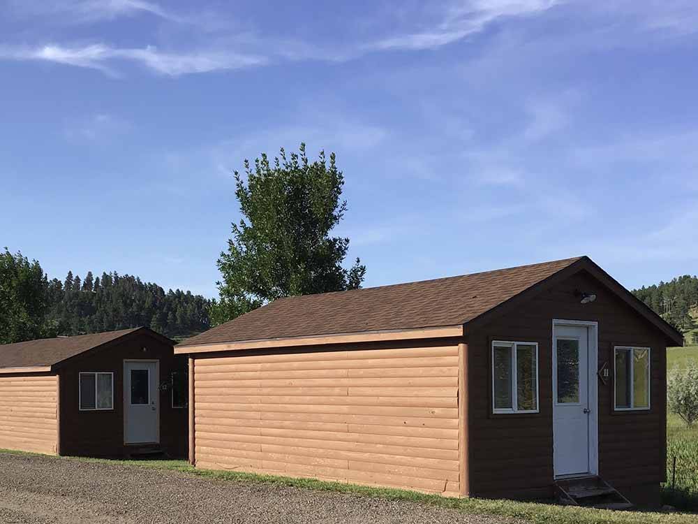 A row of rental wooden cabins at NO NAME CITY LUXURY CABINS & RV PARK