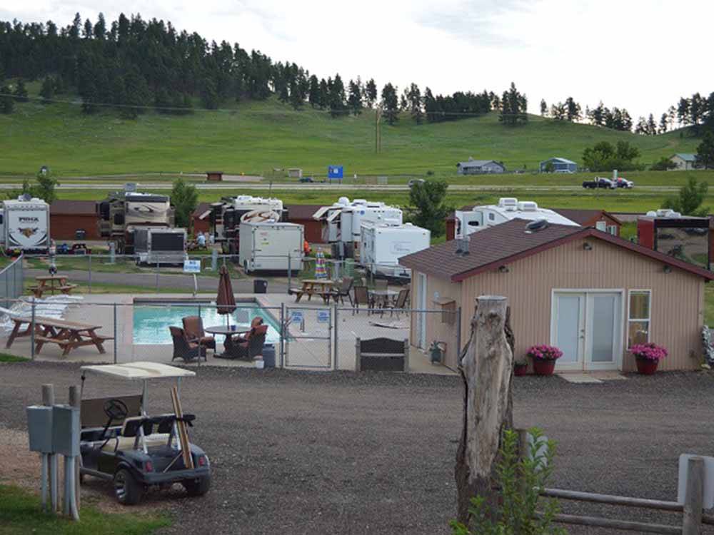 View of pool with RV sites in background at NO NAME CITY LUXURY CABINS & RV PARK