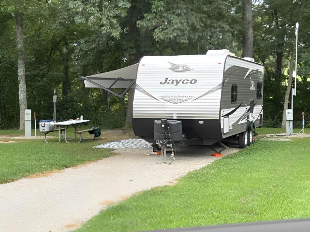 Parked trailer next to panic table at Ozark Outdoors/Riverfront Resort