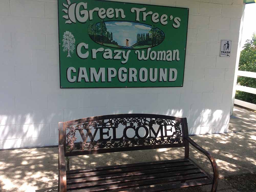 Campground sign and welcome bench at GREEN TREE'S CRAZY WOMAN CAMPGROUND
