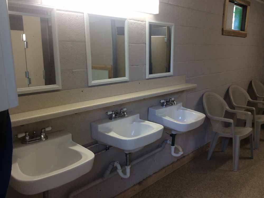 Sinks and mirrors in the bathroom at GREEN TREE'S CRAZY WOMAN CAMPGROUND