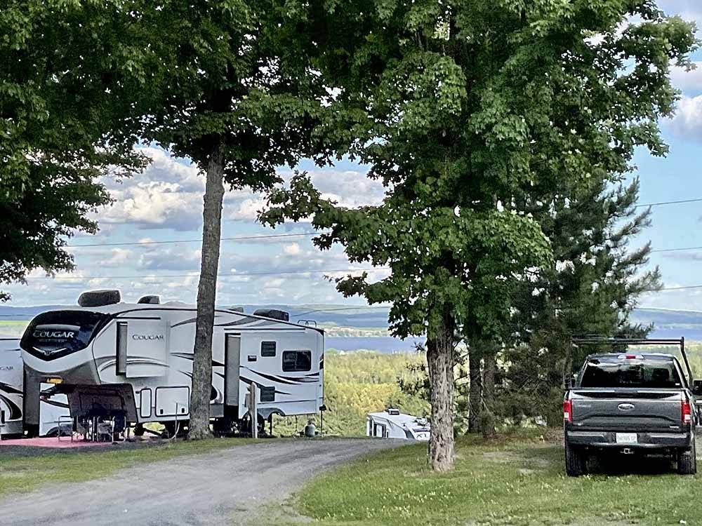 A gravel road between two RV sites at LAKEVIEW CAMPING RESORT