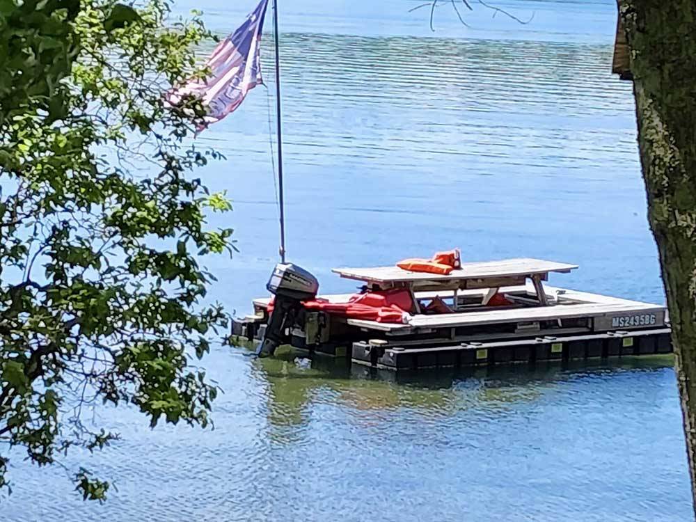 A pontoon boat that looks like a picnic table at DUNROAMIN' TRAILER PARK & COTTAGES