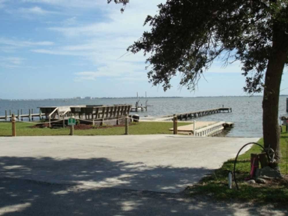 View of the waterfront with docks at WHISPERING PINES CAMPGROUND