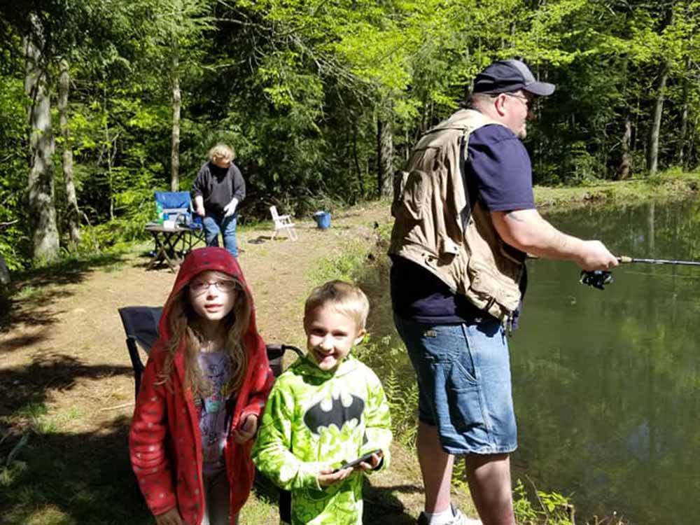 A family fishing in the pond at WOODLAND PARK