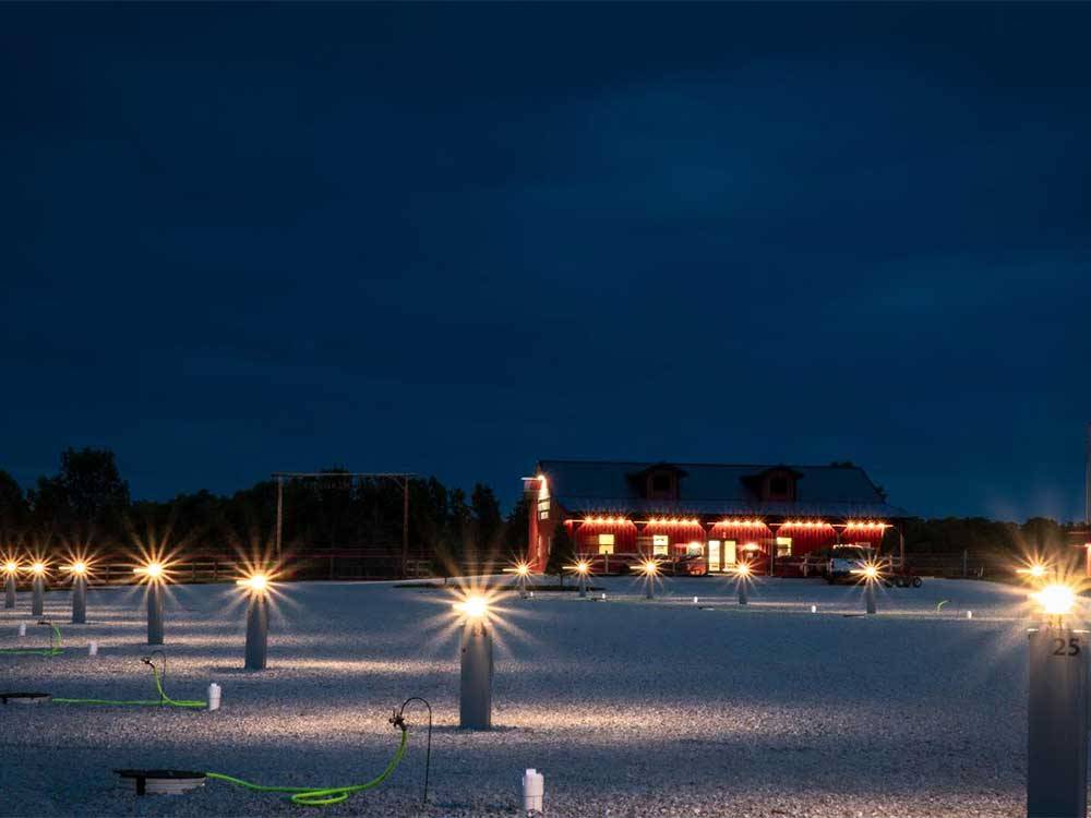 Lighted vacant sites at night at RUSTIC MEADOWS RV PARK