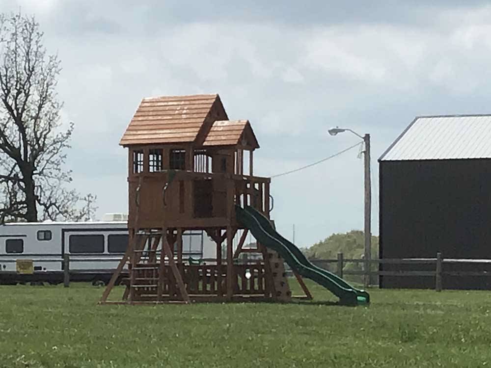 Tall kids play structure with slide at RUSTIC MEADOWS RV PARK