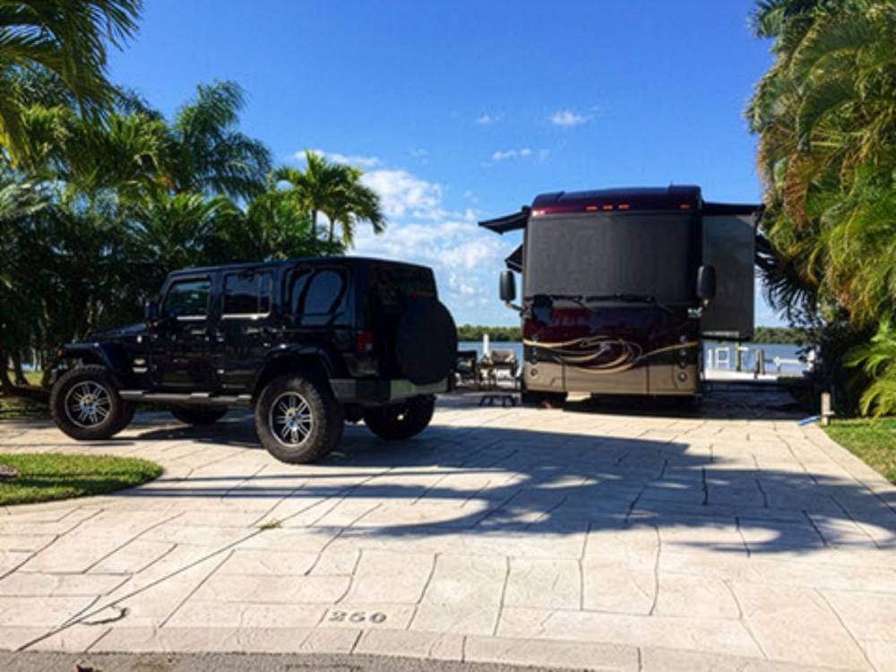 A motorhome and vehicle in a paved site