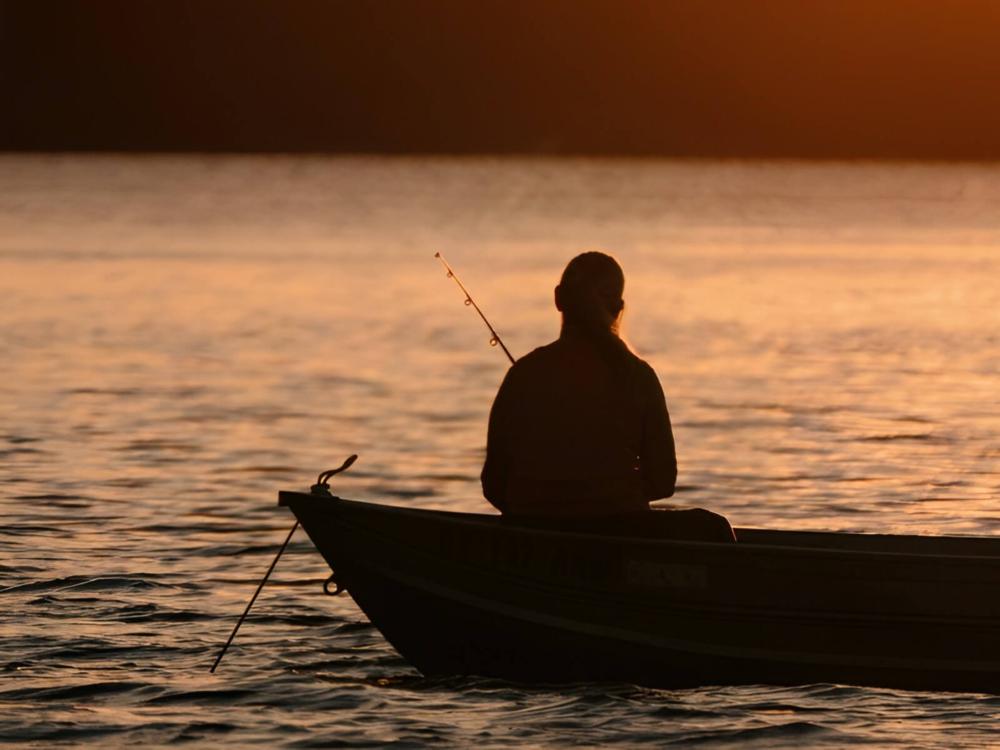 Person fishing in a boat at site Fairview Park Camping & Marina
