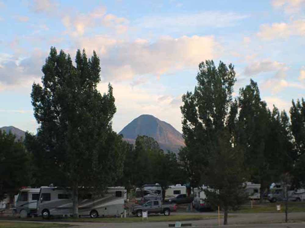 The RV sites with a mountain in the background at SLEEPING UTE RV PARK