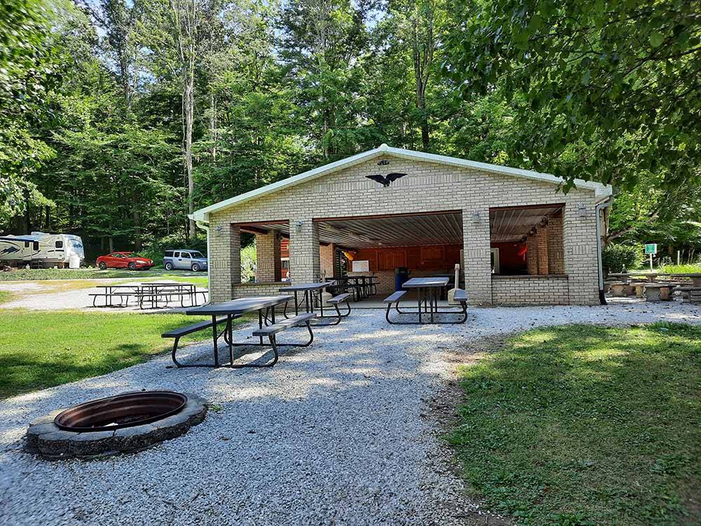 Fire pit, picnic tables and pavilion at HIDDEN PARADISE CAMPGROUND