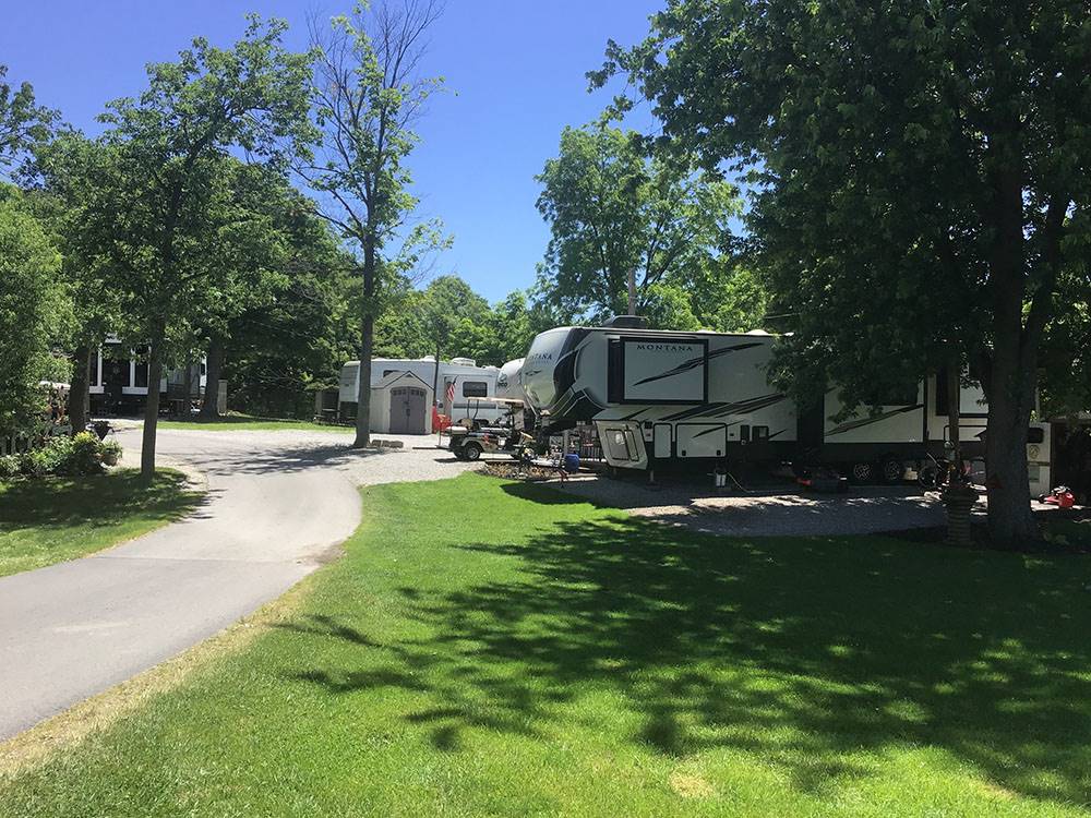 RVs in the shade under trees at Clinton Lake Camping