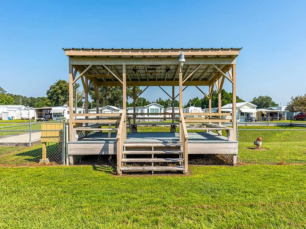 A stage around the fenced in pet area at SANDBAR RV RESORT