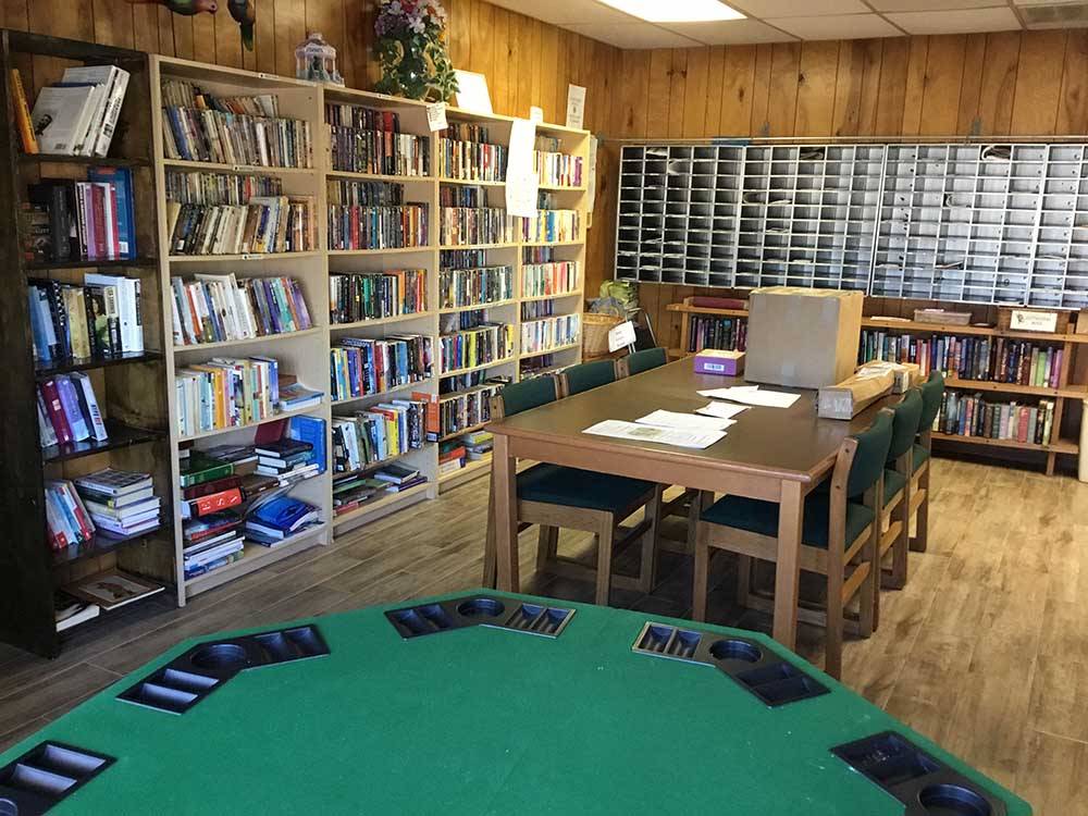 A poker table and library at PALMDALE RV RESORT