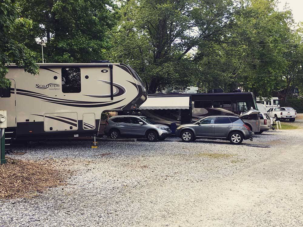 A row of RVs in gravel sites at YONAH MOUNTAIN CAMPGROUND