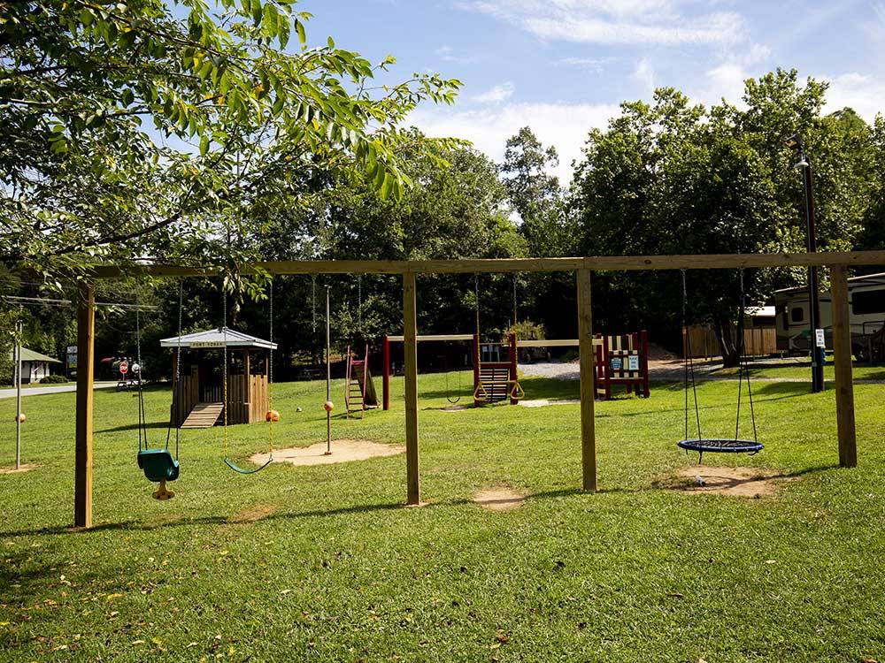 Swing set on a grass playground at YONAH MOUNTAIN CAMPGROUND