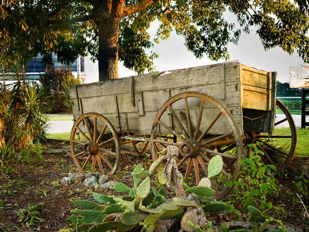 An old wooden wagon in a planter at SOUTHERN TRAILS RV RESORT