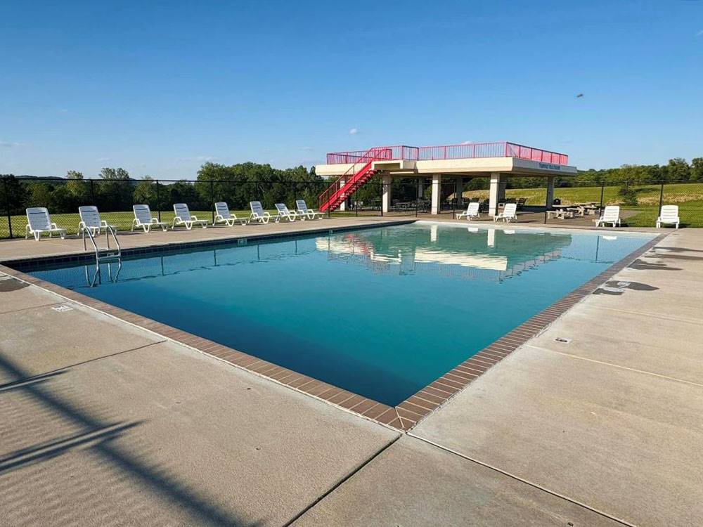 Pool area with lounge chairs at Heavenly Hills Resort