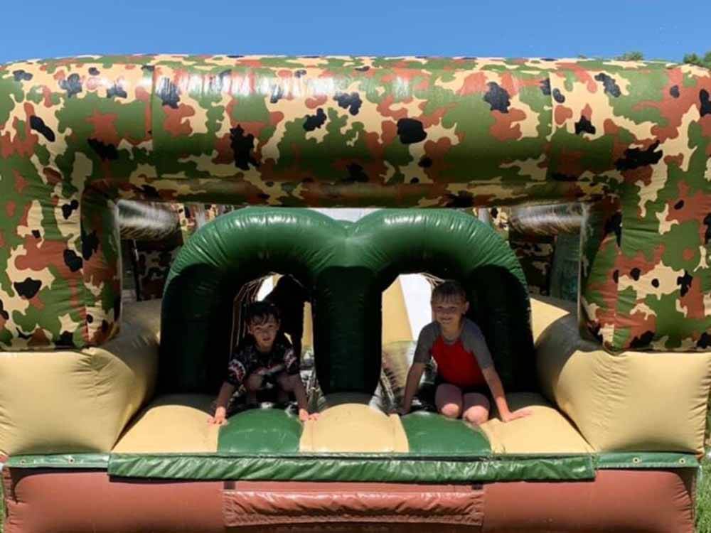 Kids playing on an inflatable slide at O'SULLIVAN SPORTSMAN RESORT (CAMPING RESORT)