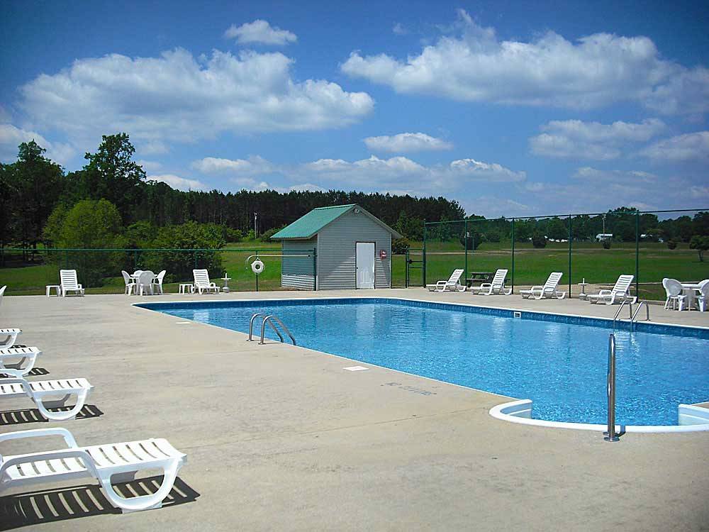 Swimming pool with outdoor seating at THOUSAND TRAILS HIDDEN COVE