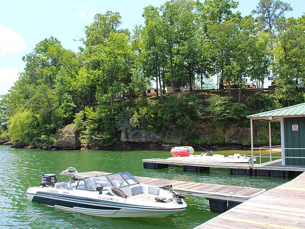 Boat docked on lake at THOUSAND TRAILS HIDDEN COVE