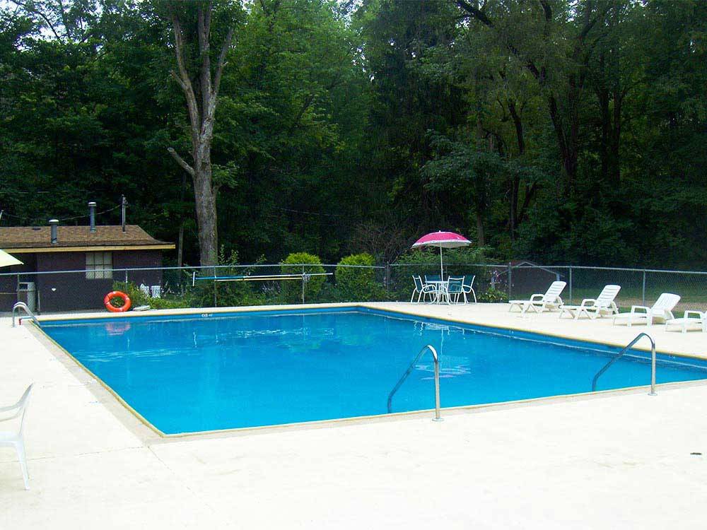 Swimming pool with outdoor seating at THOUSAND TRAILS BEAR CAVE