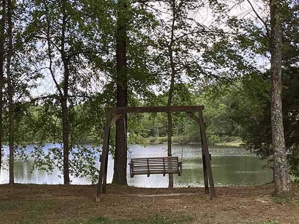 A swing by the water at WENDY OAKS RV RESORT