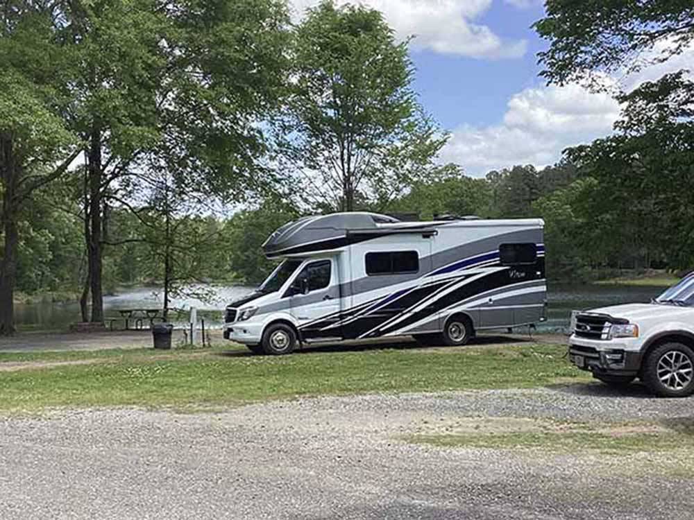 A row of RV sites by the water at WENDY OAKS RV RESORT