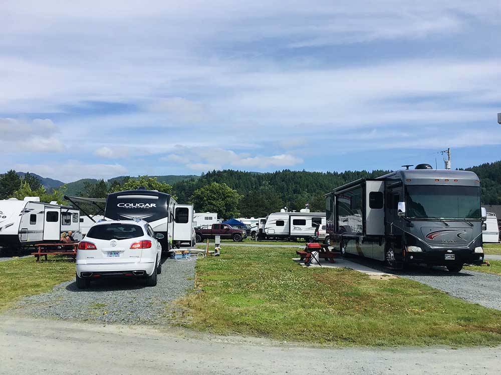 A motorhome parked in a gravel site at OLD MILL RV RESORT